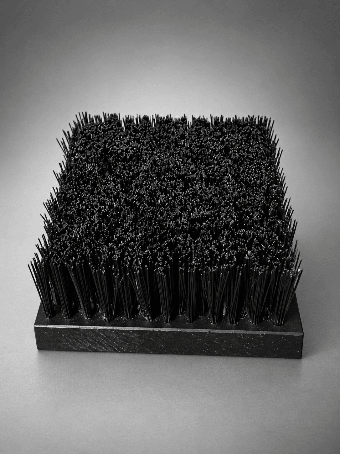 Black sole scrub brush block, 204 x 150 x 20 mm, viewed from the front